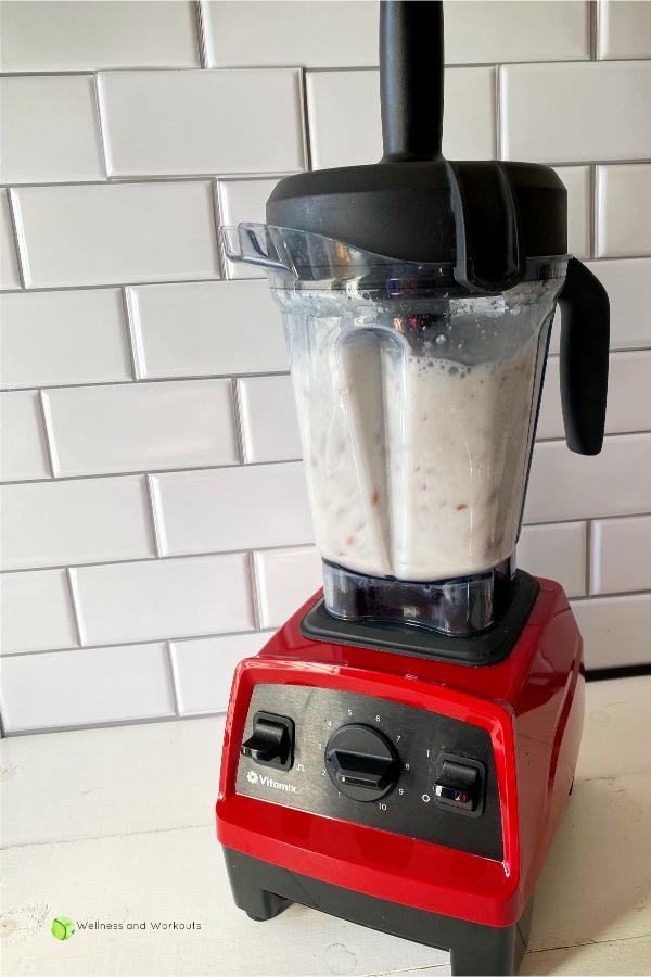 Soaked organic raw almonds being blended with filtered water to make Vitamix almond milk.