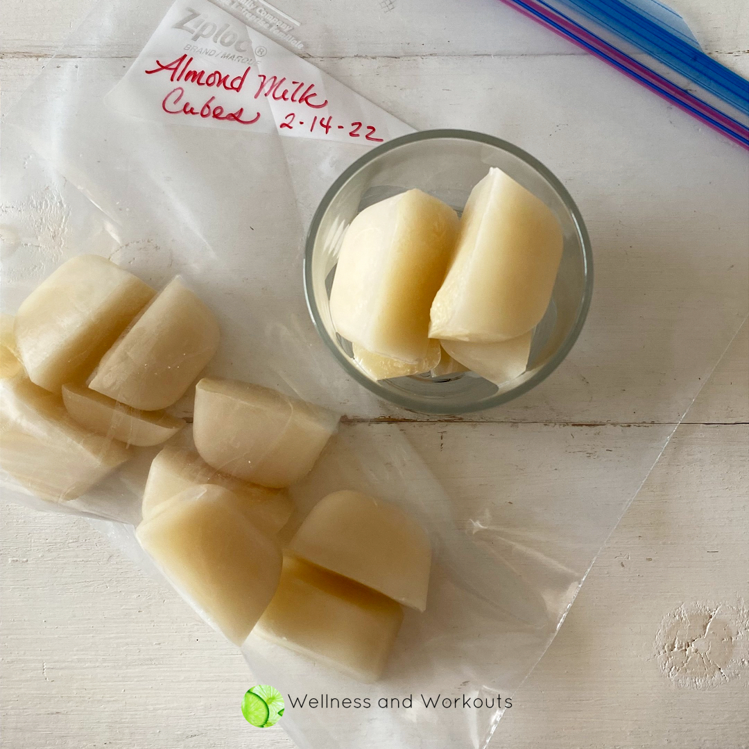Frozen cubes of homemade Vitamix almond milk ready to save in a plastic baggie for making quick smoothies and other recipes.