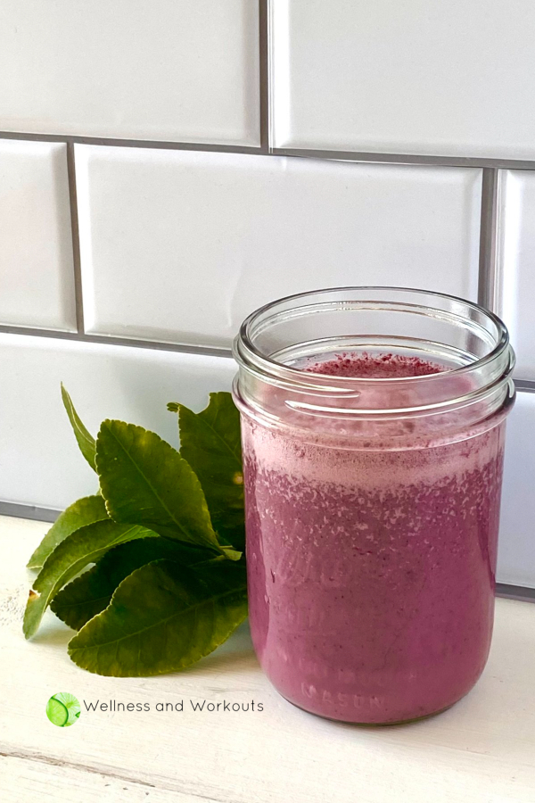 Frozen fruit smoothie for weight loss in a ball jar, with some lemon leaves in the background.