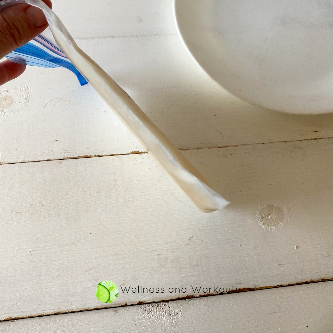 A side view of the frozen baggie of almond milk. Nice and thin, easy to break into pieces and place in a Vitamix blender or saucepan.