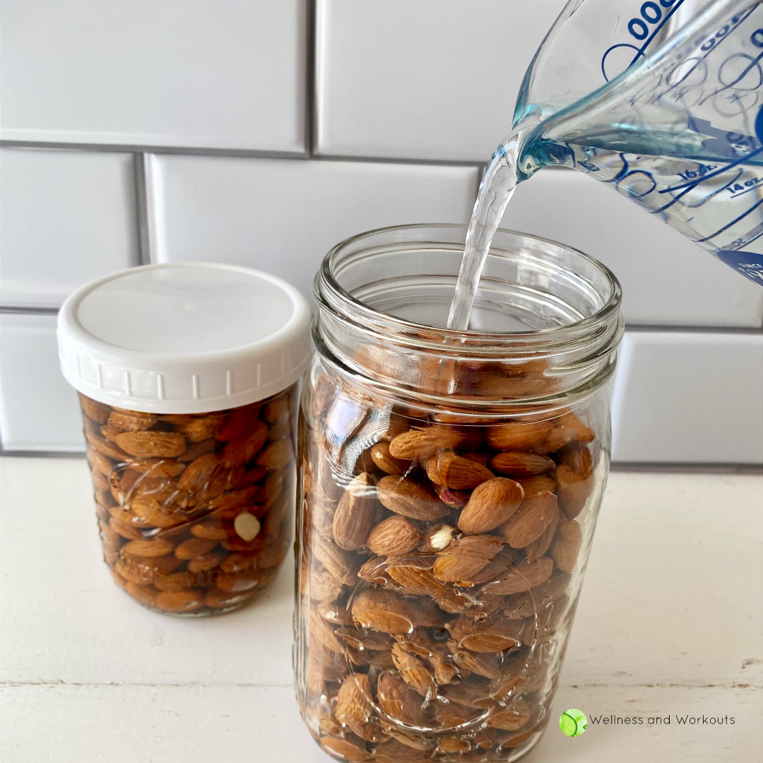 Pouring filtered water into a mason jar filled with organic raw almonds.