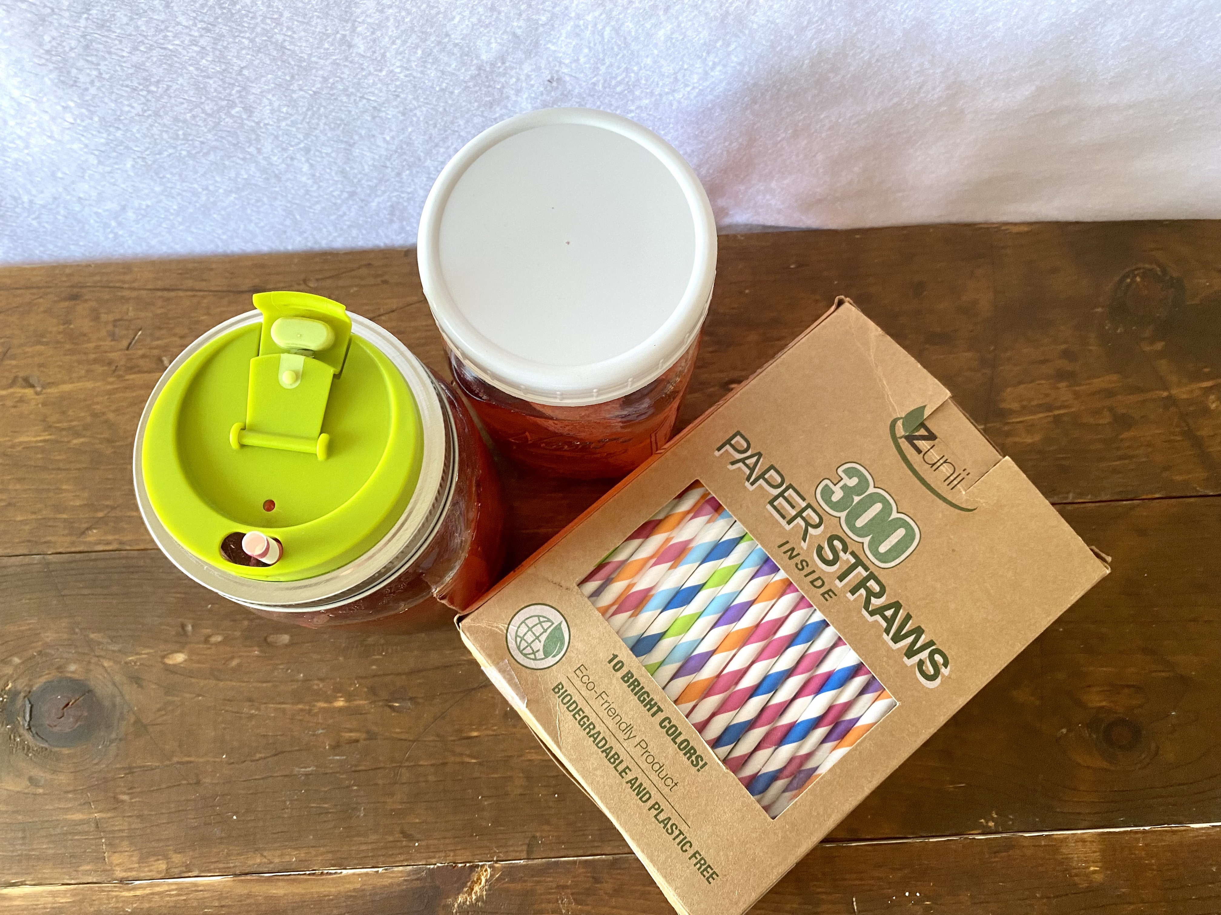 Canning jars with lids and straws, perfect for taking your weight loss smoothie or spa water with you on the go. This is a top view.